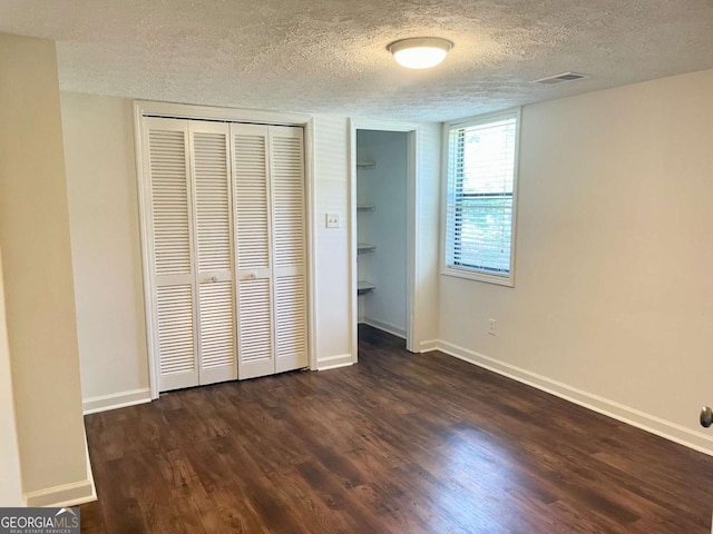 1028 Gate Post Ln, Lawrenceville, GA 30044 - unfurnished bedroom with a textured ceiling, wood finished floors, baseboards, and a closet