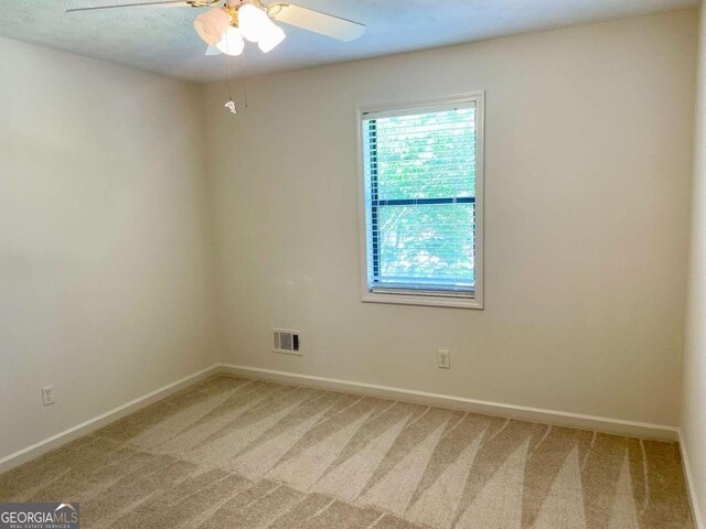 1028 Gate Post Ln, Lawrenceville, GA 30044 - empty room featuring light colored carpet, baseboards, and ceiling fan