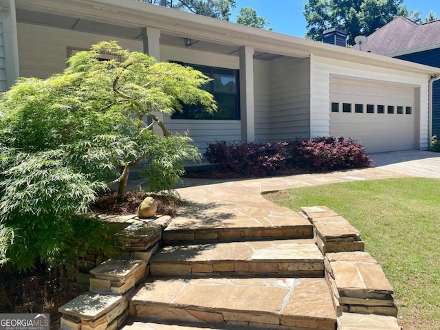 1028 Gate Post Ln, Lawrenceville, GA 30044 - view of home's exterior featuring an attached garage, concrete driveway, a chimney, and a lawn