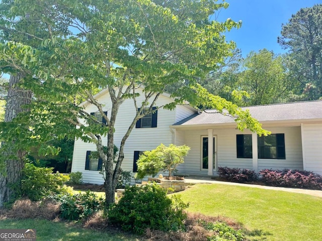 1028 Gate Post Ln, Lawrenceville, GA 30044 - view of front of house featuring a front yard and roof with shingles