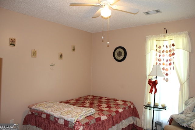 239 Ferguson Ave, Locust Grove, GA 30248 - bedroom with ceiling fan and a textured ceiling