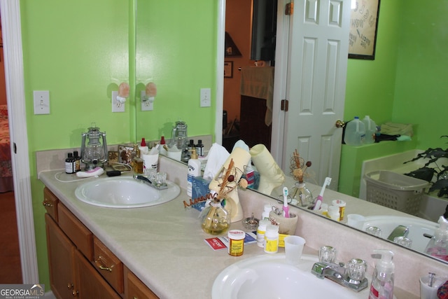 239 Ferguson Ave, Locust Grove, GA 30248 - bathroom featuring double vanity and ensuite bath