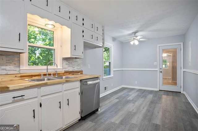 444 Polk Ln, Dallas, GA 30132 - kitchen featuring stainless steel dishwasher, a sink, tasteful backsplash, ceiling fan, and white cabinetry