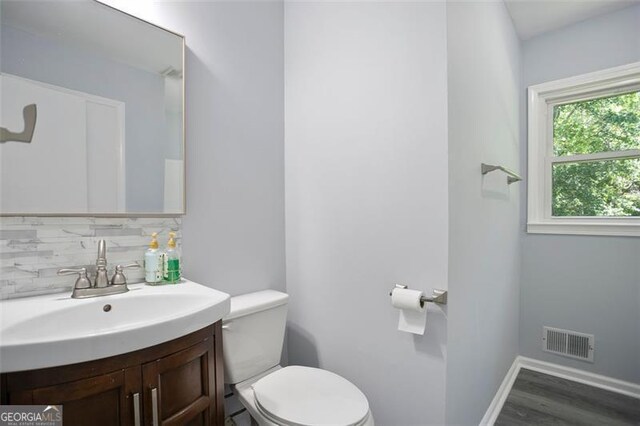 444 Polk Ln, Dallas, GA 30132 - bathroom with toilet, vanity, wood finished floors, tasteful backsplash, and baseboards
