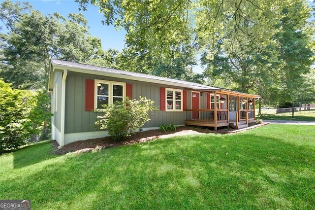 444 Polk Ln, Dallas, GA 30132 - ranch-style house featuring a front lawn and a wooden deck