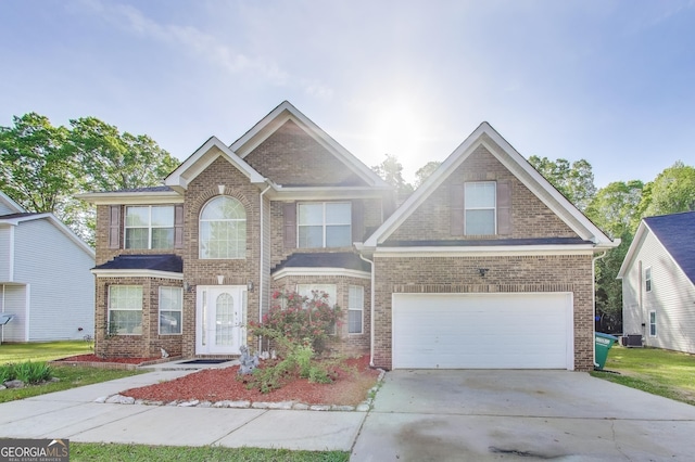 365 Othello Dr, Hampton, GA 30228 - view of front of house with a garage, concrete driveway, central air condition unit, and brick siding