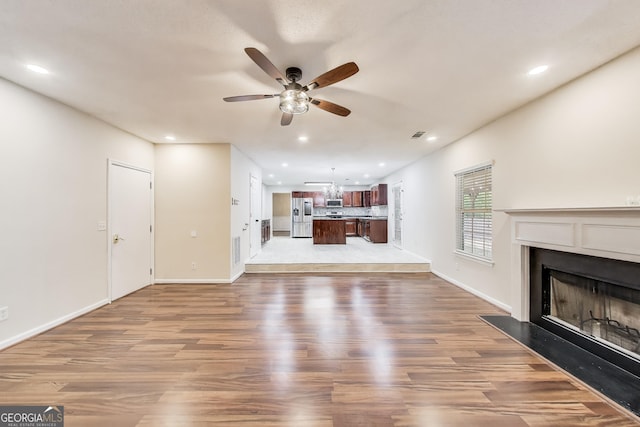 365 Othello Dr, Hampton, GA 30228 - unfurnished living room with ceiling fan, wood finished floors, a fireplace, recessed lighting, and baseboards