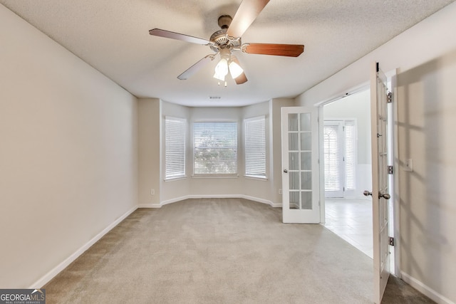 365 Othello Dr, Hampton, GA 30228 - spare room featuring carpet, french doors, ceiling fan, baseboards, and a textured ceiling