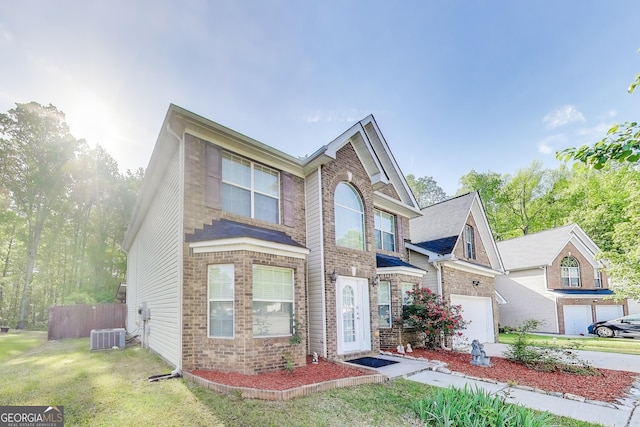 365 Othello Dr, Hampton, GA 30228 - traditional-style house with brick siding, central AC unit, and concrete driveway