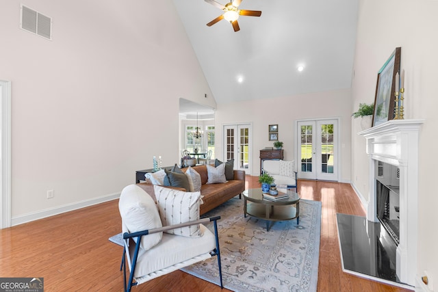 125 Lake Park Dr, Sharpsburg, GA 30277 - living room featuring high vaulted ceiling, ceiling fan, french doors, plenty of natural light, and wood finished floors