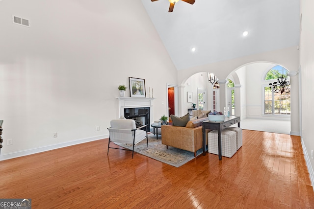 125 Lake Park Dr, Sharpsburg, GA 30277 - living area with arched walkways, high vaulted ceiling, decorative columns, ceiling fan, and hardwood / wood-style flooring