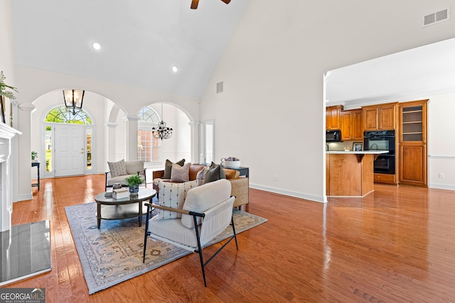 125 Lake Park Dr, Sharpsburg, GA 30277 - living area with high vaulted ceiling, arched walkways, recessed lighting, ceiling fan, and light wood-style floors