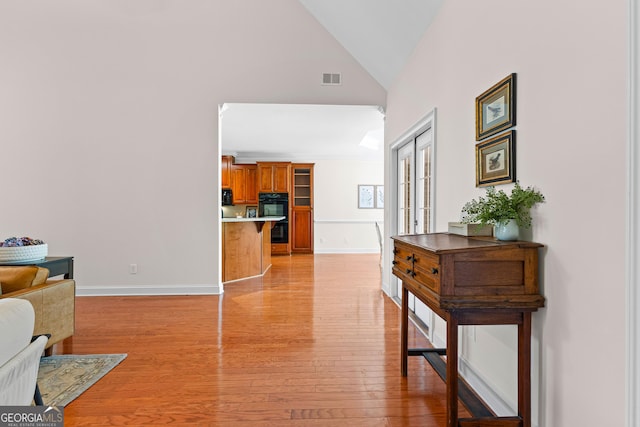 125 Lake Park Dr, Sharpsburg, GA 30277 - living room featuring light wood-style floors, high vaulted ceiling, baseboards, and french doors