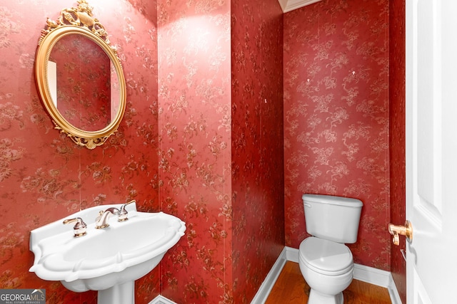 125 Lake Park Dr, Sharpsburg, GA 30277 - half bathroom with wood finished floors, baseboards, and toilet