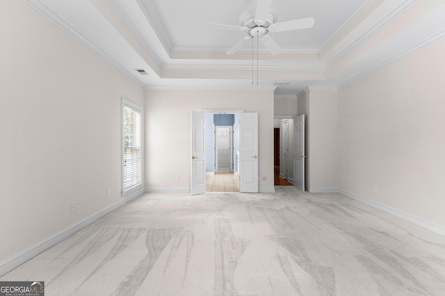 125 Lake Park Dr, Sharpsburg, GA 30277 - unfurnished bedroom with a tray ceiling, light carpet, crown molding, baseboards, and a ceiling fan
