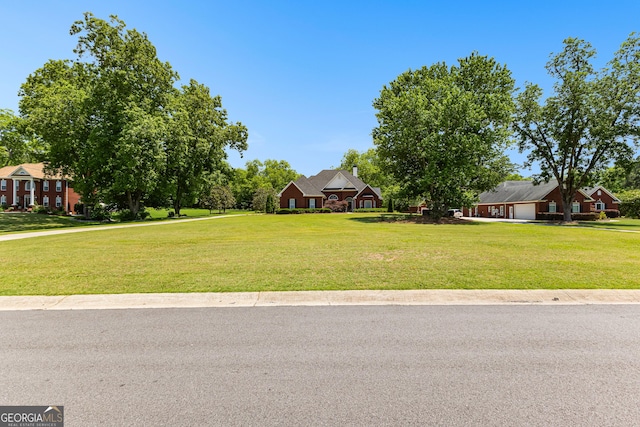 125 Lake Park Dr, Sharpsburg, GA 30277 - view of grassy yard with an attached garage
