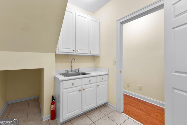 125 Lake Park Dr, Sharpsburg, GA 30277 - laundry area with a sink, light tile patterned floors, and baseboards