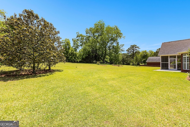 125 Lake Park Dr, Sharpsburg, GA 30277 - view of green lawn with a sunroom