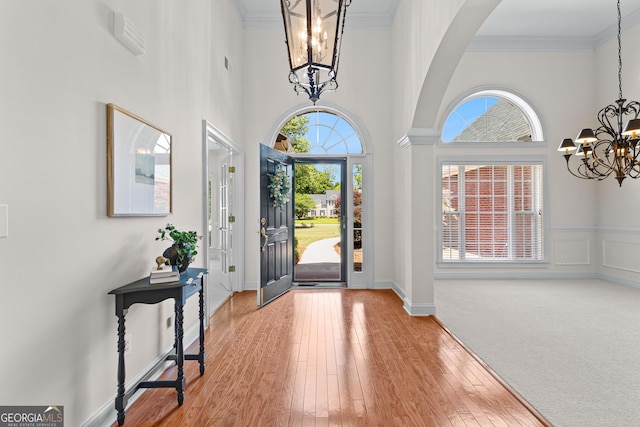 125 Lake Park Dr, Sharpsburg, GA 30277 - foyer with a chandelier, healthy amount of natural light, arched walkways, wood finished floors, and a towering ceiling