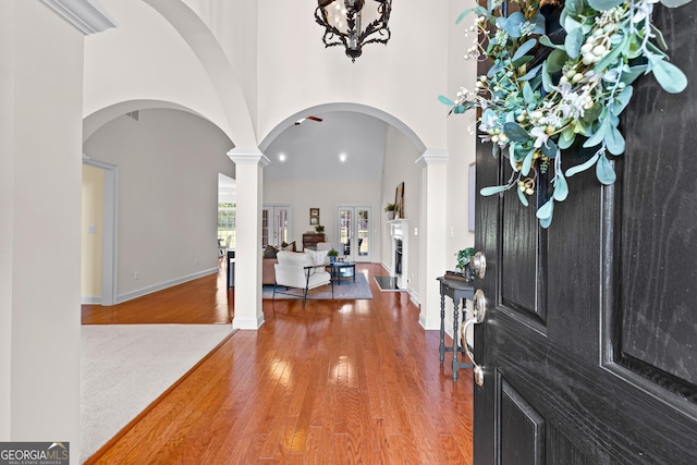 125 Lake Park Dr, Sharpsburg, GA 30277 - foyer featuring wood finished floors, a high ceiling, arched walkways, and ornate columns