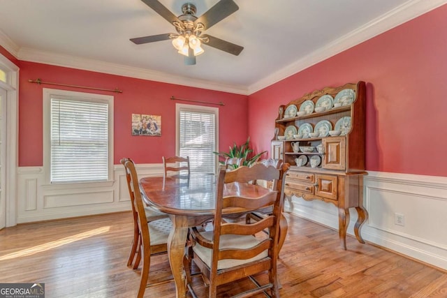 211 Westwood Dr, Calhoun, GA 30701 - dining area with light wood-type flooring, a ceiling fan, wainscoting, and ornamental molding