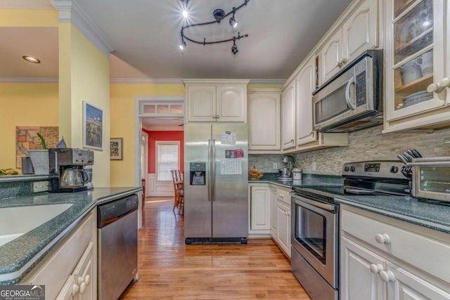 211 Westwood Dr, Calhoun, GA 30701 - kitchen featuring stainless steel appliances, light wood-style floors, tasteful backsplash, glass insert cabinets, and crown molding