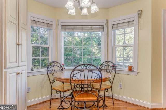 211 Westwood Dr, Calhoun, GA 30701 - dining space featuring a chandelier, baseboards, and light wood-style flooring