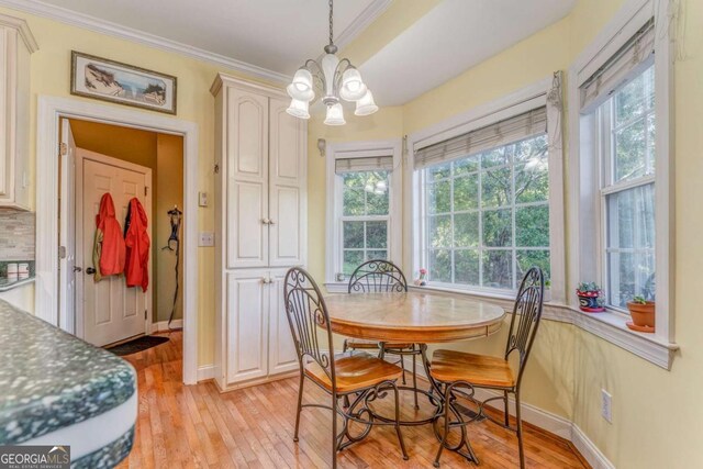 211 Westwood Dr, Calhoun, GA 30701 - dining space with light wood-style floors, crown molding, healthy amount of natural light, and a chandelier