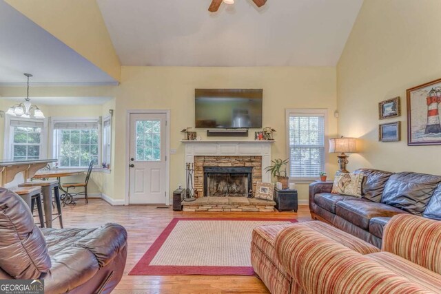 211 Westwood Dr, Calhoun, GA 30701 - living area featuring plenty of natural light, wood finished floors, ceiling fan, a stone fireplace, and high vaulted ceiling