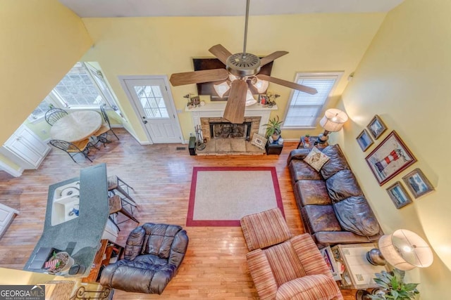 211 Westwood Dr, Calhoun, GA 30701 - living room featuring a ceiling fan, wood finished floors, and a fireplace with raised hearth