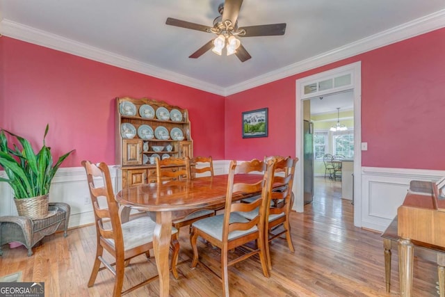 211 Westwood Dr, Calhoun, GA 30701 - dining area featuring light wood finished floors, ceiling fan, wainscoting, and crown molding