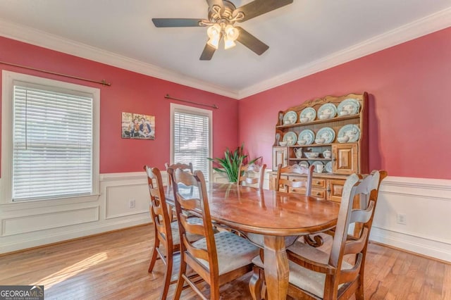 211 Westwood Dr, Calhoun, GA 30701 - dining space featuring light wood finished floors, wainscoting, ceiling fan, ornamental molding, and a decorative wall
