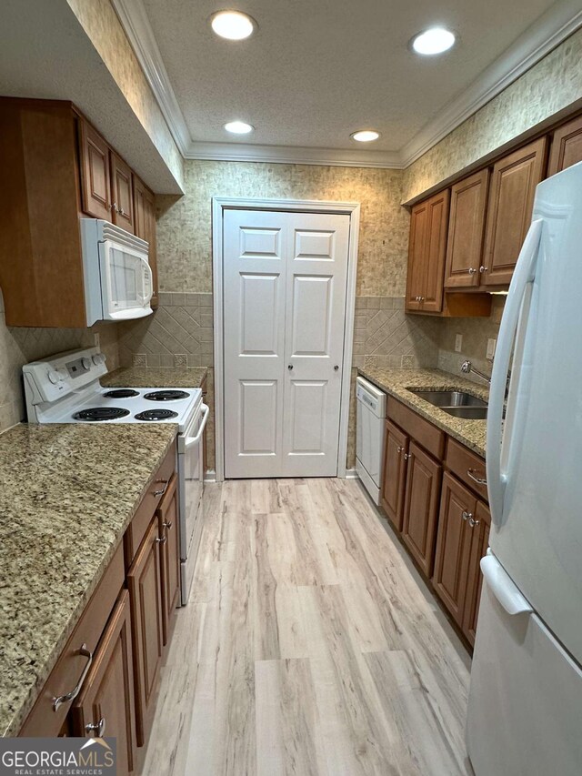 1503 Wingate Way Unit 1503, Sandy Springs, GA 30350 - kitchen with white appliances, a sink, ornamental molding, brown cabinets, and tile walls