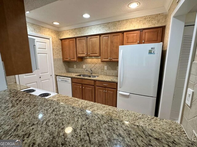 1503 Wingate Way Unit 1503, Sandy Springs, GA 30350 - kitchen with white appliances, a sink, ornamental molding, brown cabinetry, and light stone counters