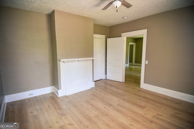 109 C St SE, Thomaston, GA 30286 - unfurnished bedroom with a textured ceiling, light wood finished floors, and ceiling fan