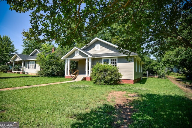 109 C St SE, Thomaston, GA 30286 - bungalow-style house featuring a porch and a front lawn
