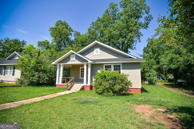 109 C St SE, Thomaston, GA 30286 - bungalow-style house featuring a porch and a front lawn