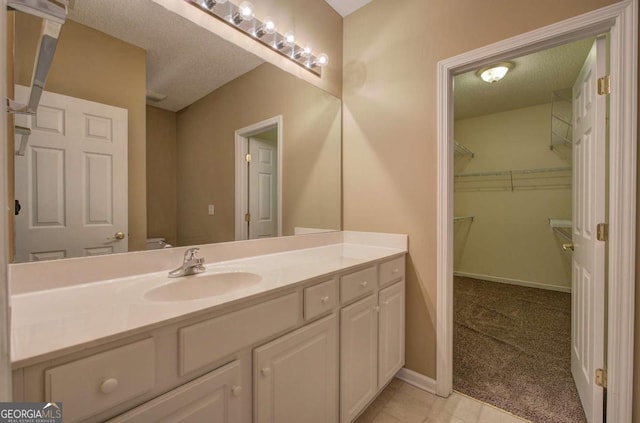580 Camry Cir, Dallas, GA 30157 - bathroom with vanity, toilet, a walk in closet, and baseboards