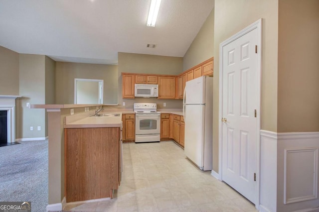 580 Camry Cir, Dallas, GA 30157 - kitchen featuring white appliances, light countertops, a peninsula, a sink, and light floors