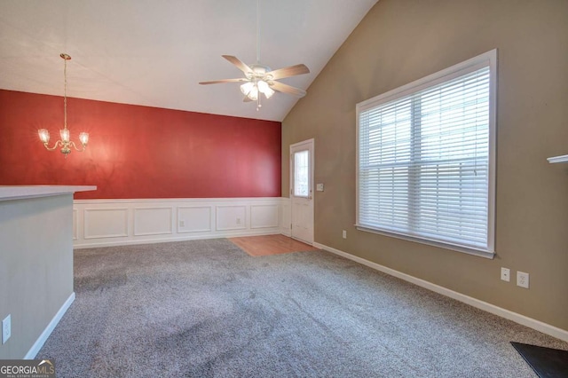 580 Camry Cir, Dallas, GA 30157 - unfurnished room featuring carpet flooring, vaulted ceiling, a ceiling fan, a chandelier, and wainscoting