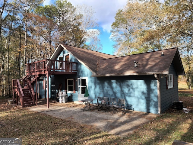 125 Toccoa Rd, Carrollton, GA 30116 - back of house featuring a deck, stairway, roof with shingles, a patio, and central AC