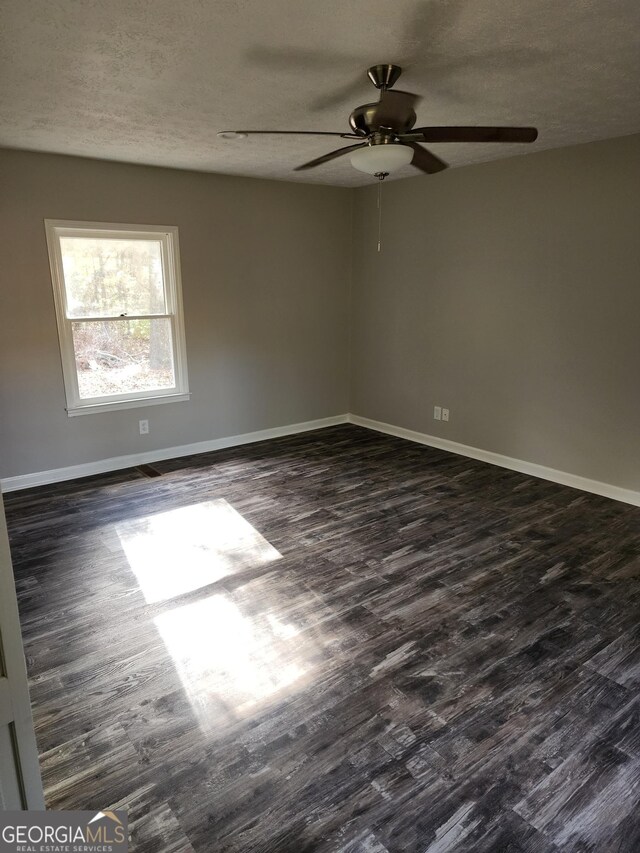 125 Toccoa Rd, Carrollton, GA 30116 - unfurnished room featuring dark wood-style flooring, ceiling fan, baseboards, and a textured ceiling