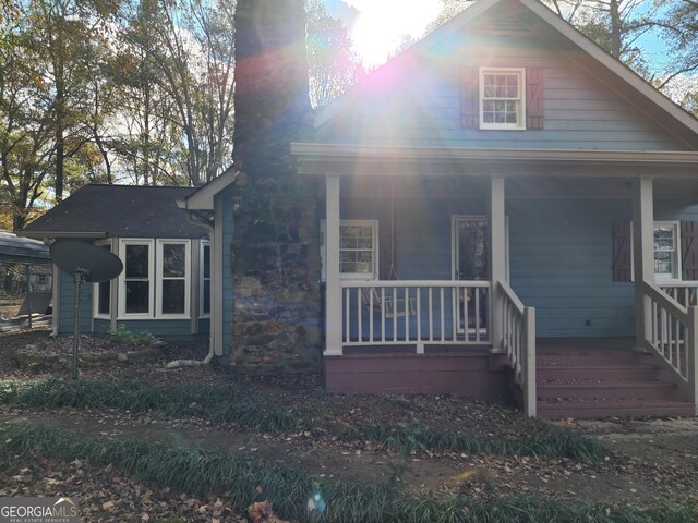 125 Toccoa Rd, Carrollton, GA 30116 - view of front facade with a porch and a chimney