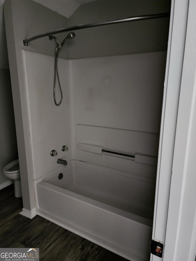 125 Toccoa Rd, Carrollton, GA 30116 - full bath with toilet, shower / washtub combination, baseboards, and wood finished floors