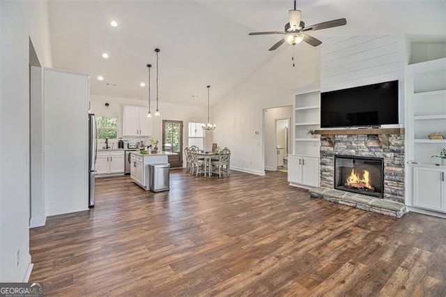 461 Barnwood, Rockmart, GA 30153 - living area featuring a fireplace, ceiling fan, high vaulted ceiling, dark wood finished floors, and a chandelier