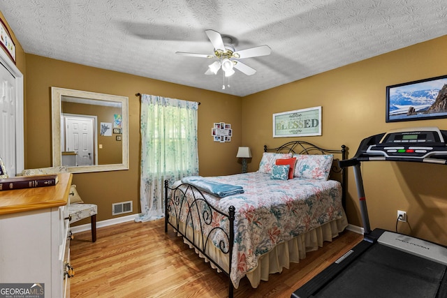 145 Adams Ct, Fayetteville, GA 30214 - bedroom featuring light wood-style floors, baseboards, ceiling fan, and a textured ceiling