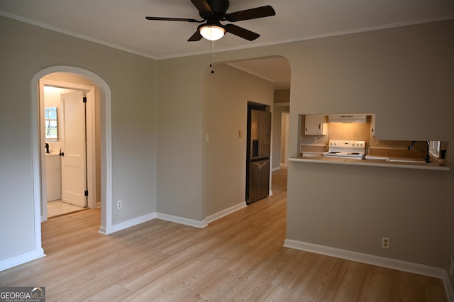 145 Mountain View Dr, Gainesville, GA 30501 - unfurnished living room with arched walkways, a ceiling fan, crown molding, light wood finished floors, and baseboards