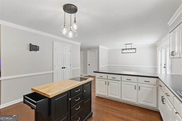 3544 Chestatee Dr, Marietta, GA 30062 - kitchen with white cabinets, dark cabinets, a peninsula, ornamental molding, and decorative light fixtures