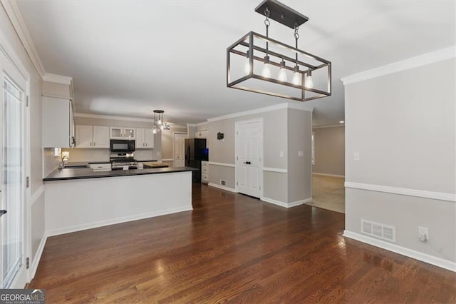 3544 Chestatee Dr, Marietta, GA 30062 - kitchen with black appliances, dark countertops, dark wood finished floors, white cabinetry, and a peninsula