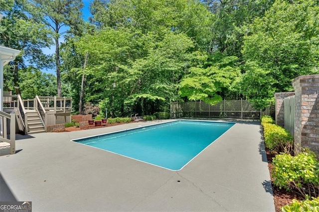 3544 Chestatee Dr, Marietta, GA 30062 - view of swimming pool featuring a deck, view of scattered trees, a patio area, and stairs